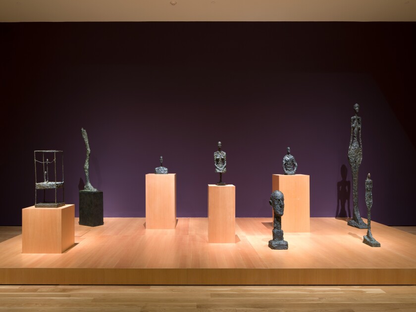 Sculptures spotlighted at a museum.
