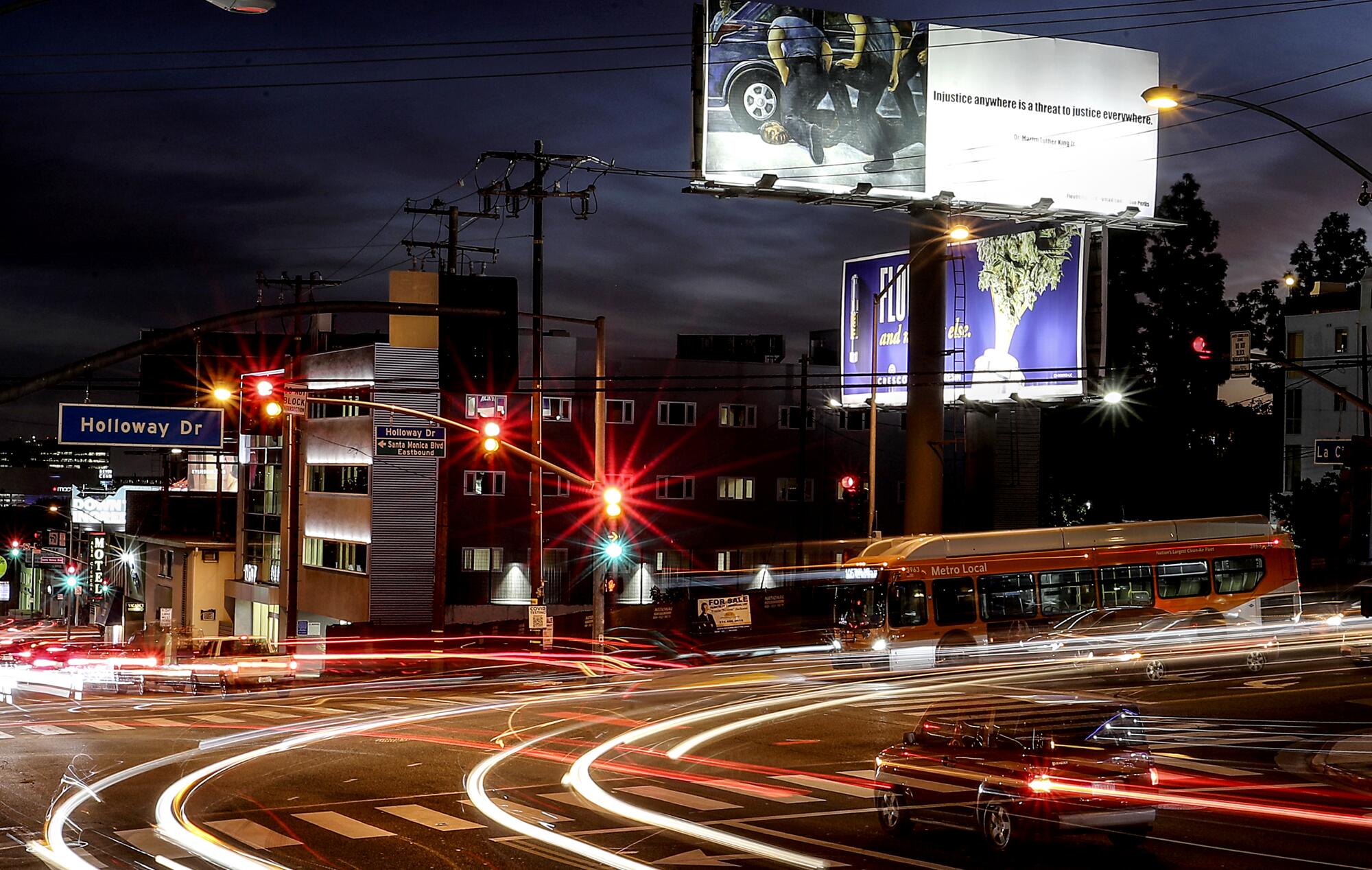 Trails of light from cars in an intersection in a long-exposure photo taken at night