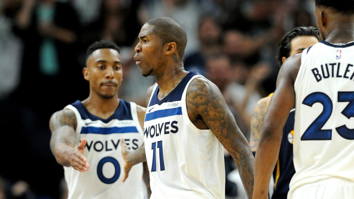 Timberwolves guard Jamal Crawford celebrates a three-point basket against the Jazz with teammates Jeff Teague (0) and Jimmy Butler during the fourth quarter Thursday night.
