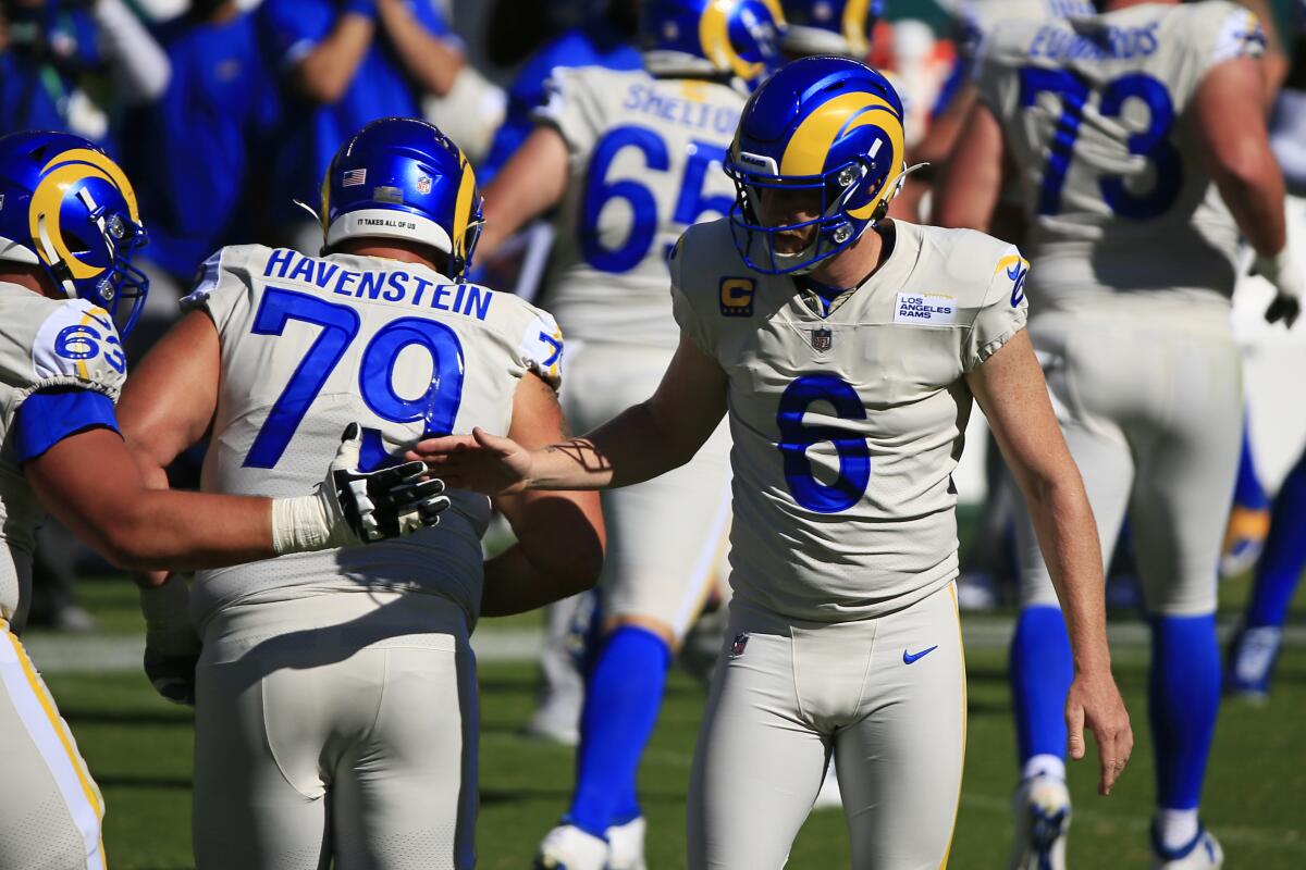 Rams punter Johnny Hekker (6) greets teammate offensive guard Austin Corbett in Week 2 against the Philadelphia Eagles.