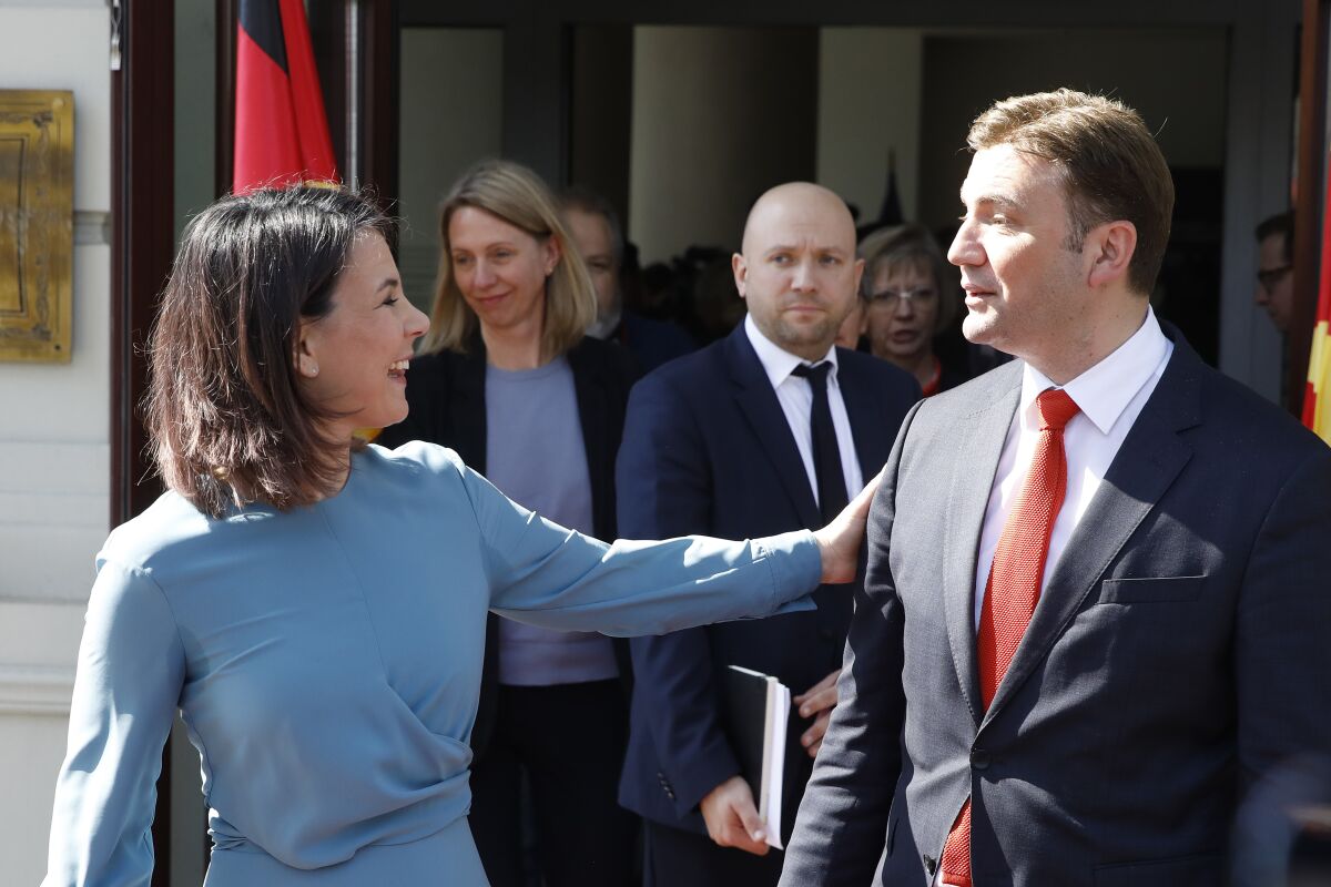German Foreign Minister Annalena Baerbock, left, greets her North Macedonia's counterpart Bujar Osmani following their meeting at the foreign ministry in Skopje, North Macedonia, on Thursday, March 23. 2023. (AP Photo/Boris Grdanoski)