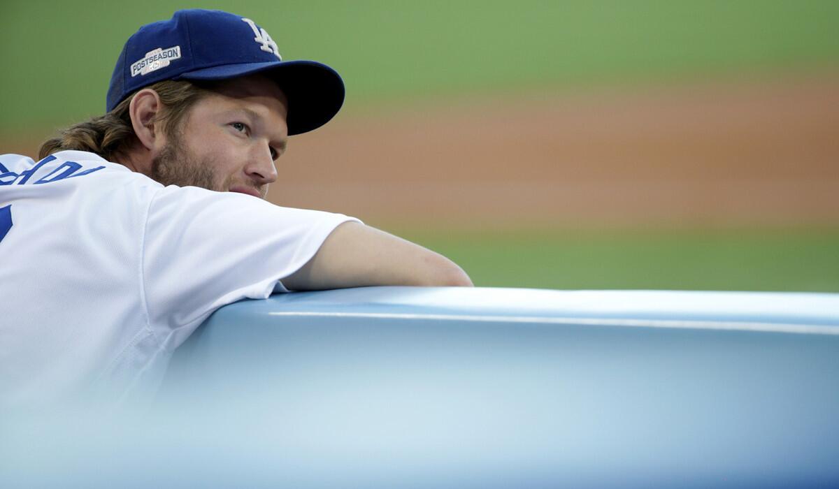 Dodgers pitcher Clayton Kershaw looks on from the dugout during Game 5 of the National League Championship Series against the Chicago Cubs on Thursday at Dodger Stadium.