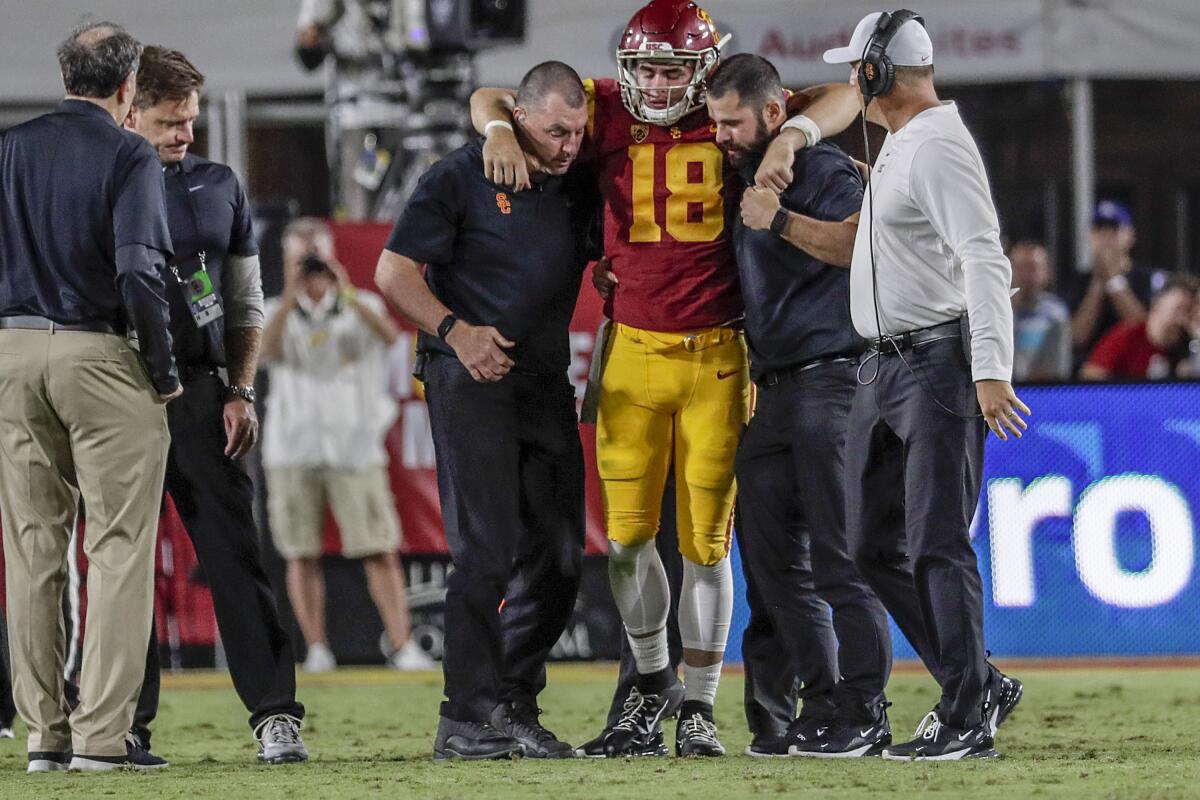 USC quarterback JT Daniels is helped to his feet