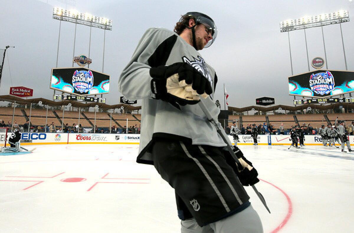 Center Anze Kopitar joins the Kings as they skate for the first time on the ice rink at Dodger Stadium on Friday night.