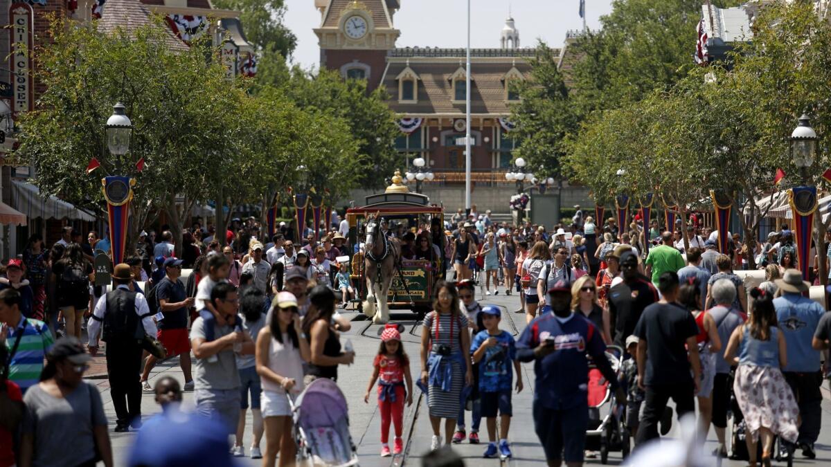 Guests along Main Street in Disneyland in 2017. The theme park is appealing a Cal-OSHA citation and fine for failing to properly clean cooling equipment linked to last year's Legionnaires' disease outbreak.