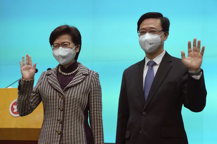 Chief Executive-elect John Lee, right, and incumbent Chief Executive Carrie Lam attend a press conference in Hong Kong, Monday, May 9, 2022. Lee was elected as the city’s next leader on Sunday in a vote cast by a largely pro-Beijing committee. (AP Photo/Kin Cheung)