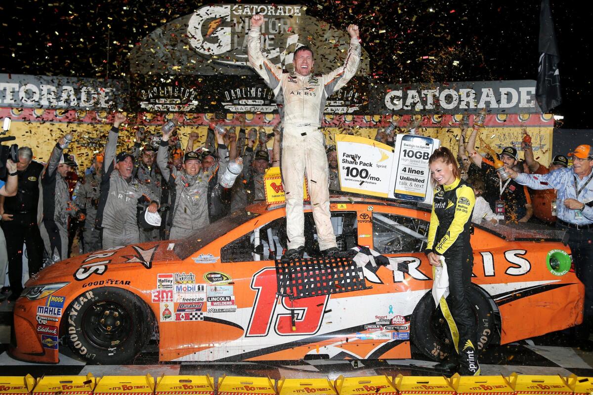 Carl Edwards, driver of the #19 ARRIS Toyota, celebrates after winning the Bojangles' Southern 500 at Darlington Raceway.