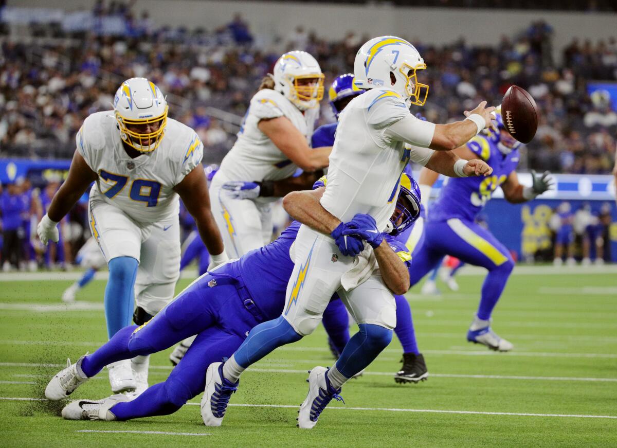 Rams linebacker Justin Lawler sacks Chargers quarterback Chase Daniel.