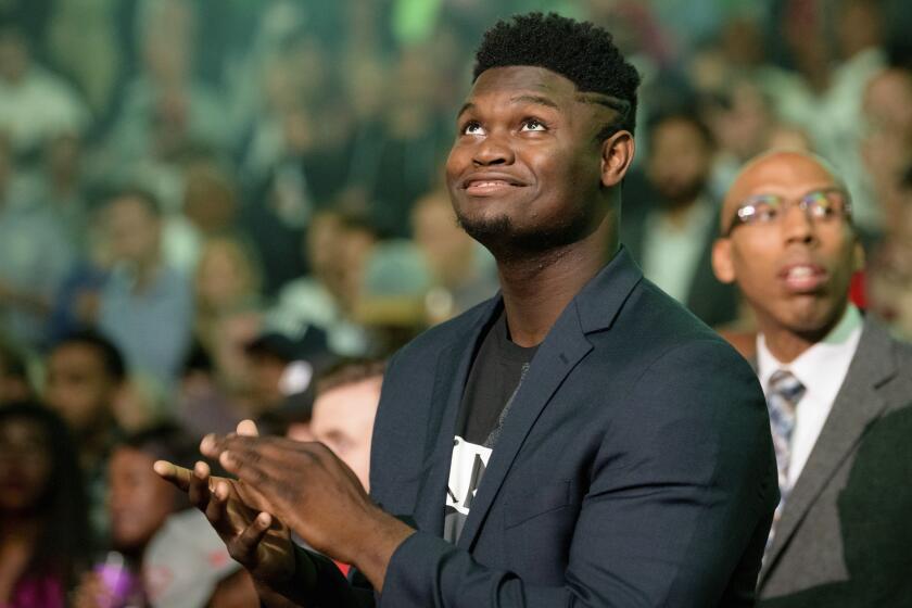 New Orleans Pelicans forward Zion Williamson watches waits for the team's NBA basketball game against the Los Angeles Lakers in New Orleans, Wednesday, Nov. 27, 2019. (AP Photo/Matthew Hinton)
