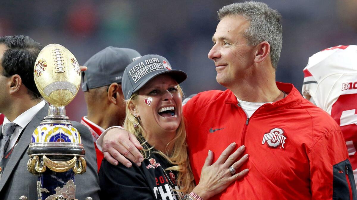 Ohio State coach Urban Meyer hugs his wife, Shelley, after their 44-28 win over Notre Dame in the Fiesta Bowl on Jan. 1, 2016.