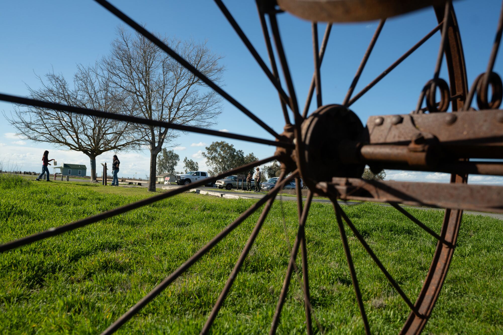 A rusted piece of farm equipment frames visitors to Colonel Allensworth State Historic Park.