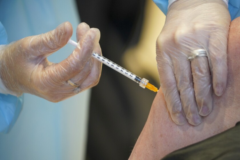 Health worker administers AstraZeneca COVID-19 vaccine