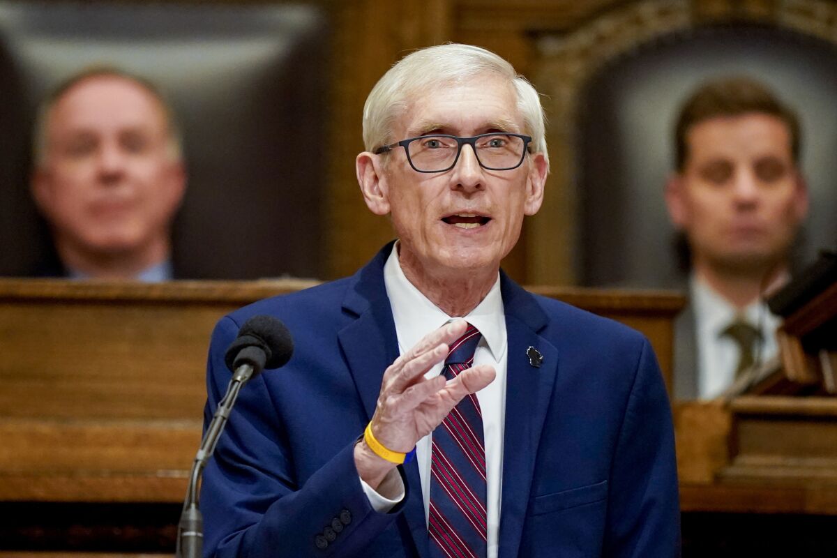 Wisconsin Gov. Tony Evers speaking into a microphone in the state Legislature