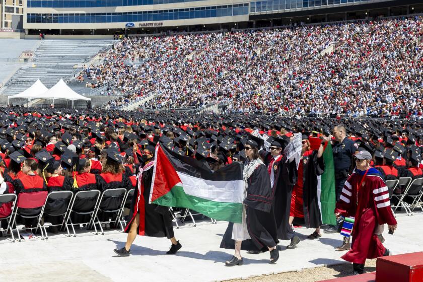 Pro-Palestinian demonstrators are escorted out of the UW-Madison Commencement ceremony after Chancellor Jennifer Mnookin's speech, at Camp Randall Stadium Madison, Wis., Saturday, May 11, 2024. (Samantha Madar/Wisconsin State Journal via AP)