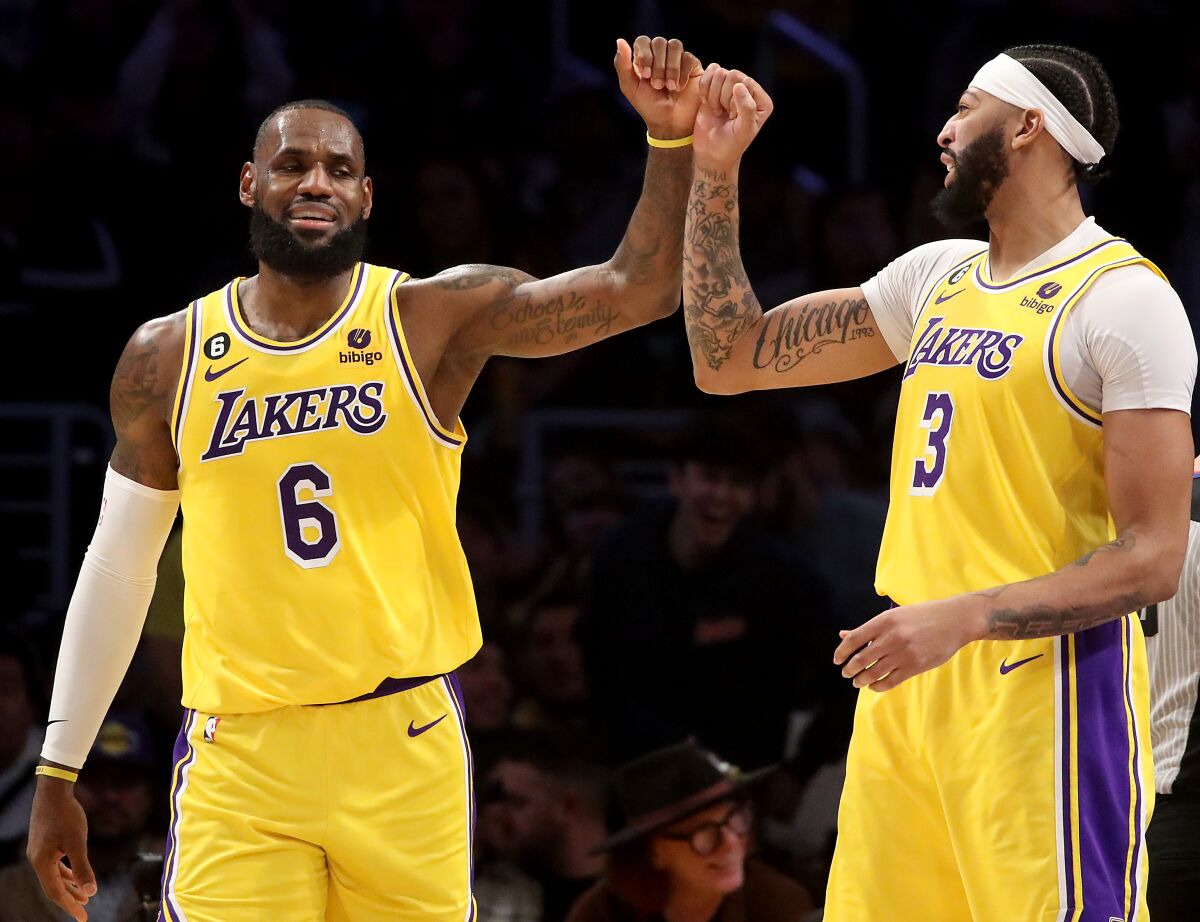 Lakers forward LeBron James celebrates with teammate Anthony Davis after scoring a basket against the Portland Trail Blazers.