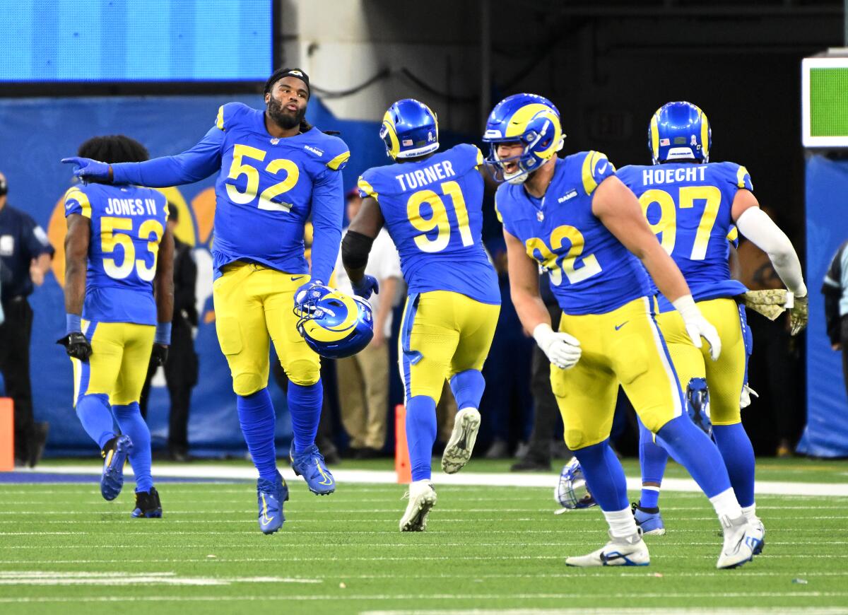 The Rams celebrate a missed field goal by Seattle after a stop by the defense.