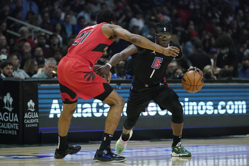 Toronto Raptors forward Thaddeus Young (21) defends against Los Angeles Clippers guard Reggie Jackson (1) during the first half of an NBA basketball game in Los Angeles, Wednesday, March 16, 2022. (AP Photo/Ashley Landis)