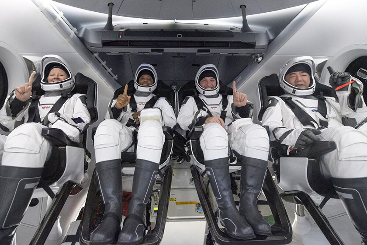 Astronauts, from left, Shannon Walker, Victor Glover, Mike Hopkins and Soichi Noguchi inside SpaceX's capsule. 