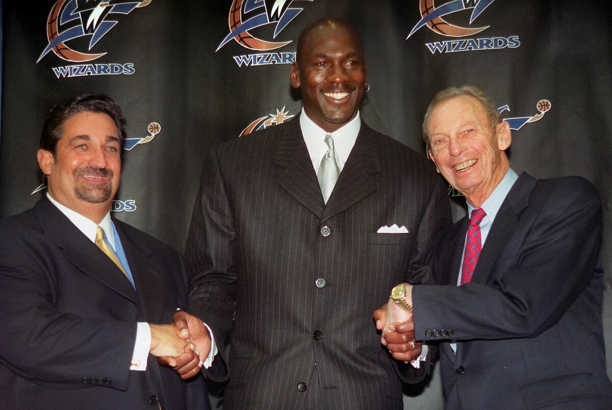 Michael Jordan is flanked by Washington Wizards owners Ted Leonsis, left, and Abe Pollin after getting hired as president of basketball operations during a news conference on Jan. 19, 2000, at MCI Center.
