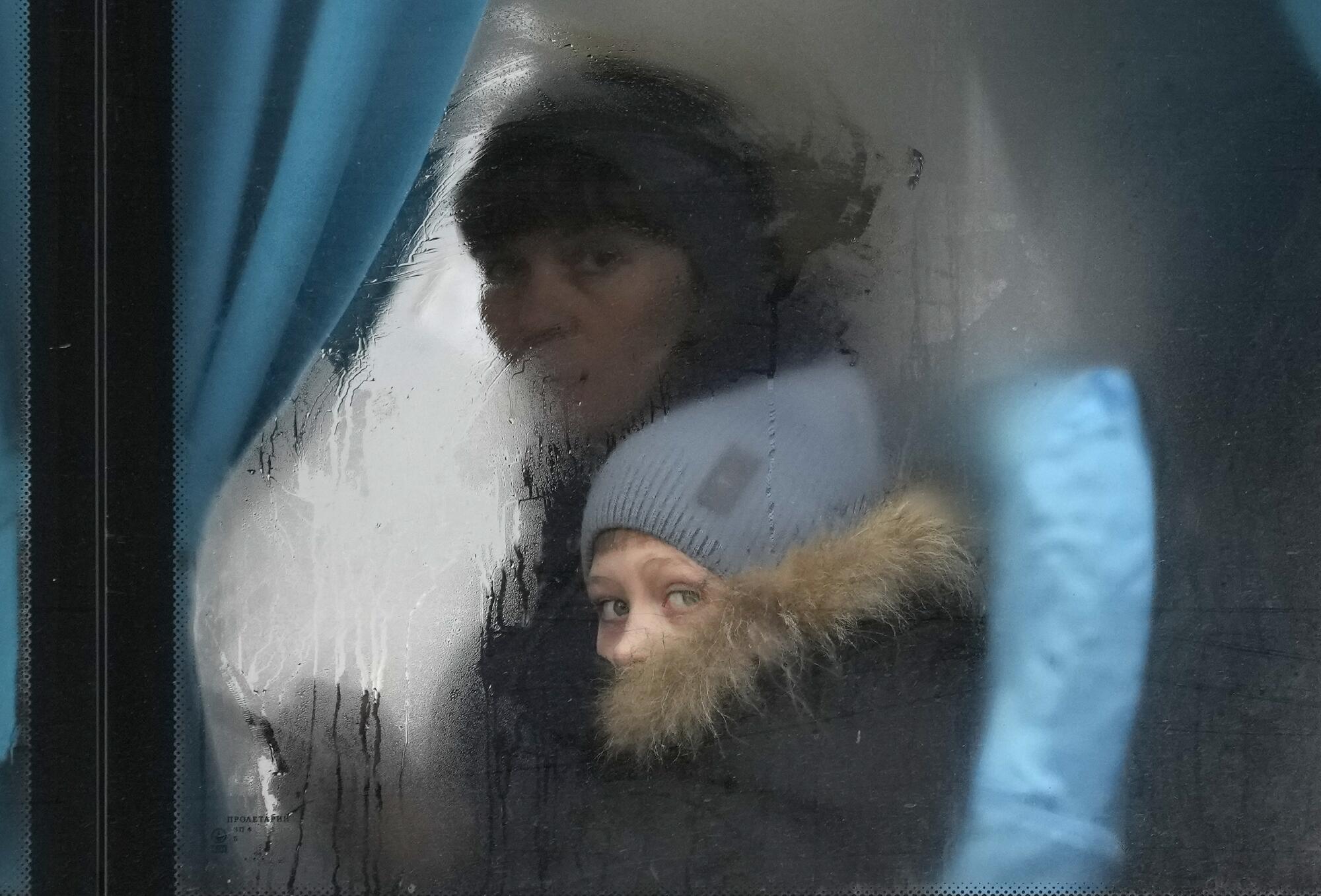 A woman and child on a bus leave the Luhansk region of eastern Ukraine.