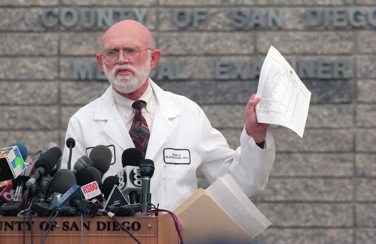 County Medical Examiner Brian Blackbourne holds the updated list of the names of 39 members of Heaven's Gate.