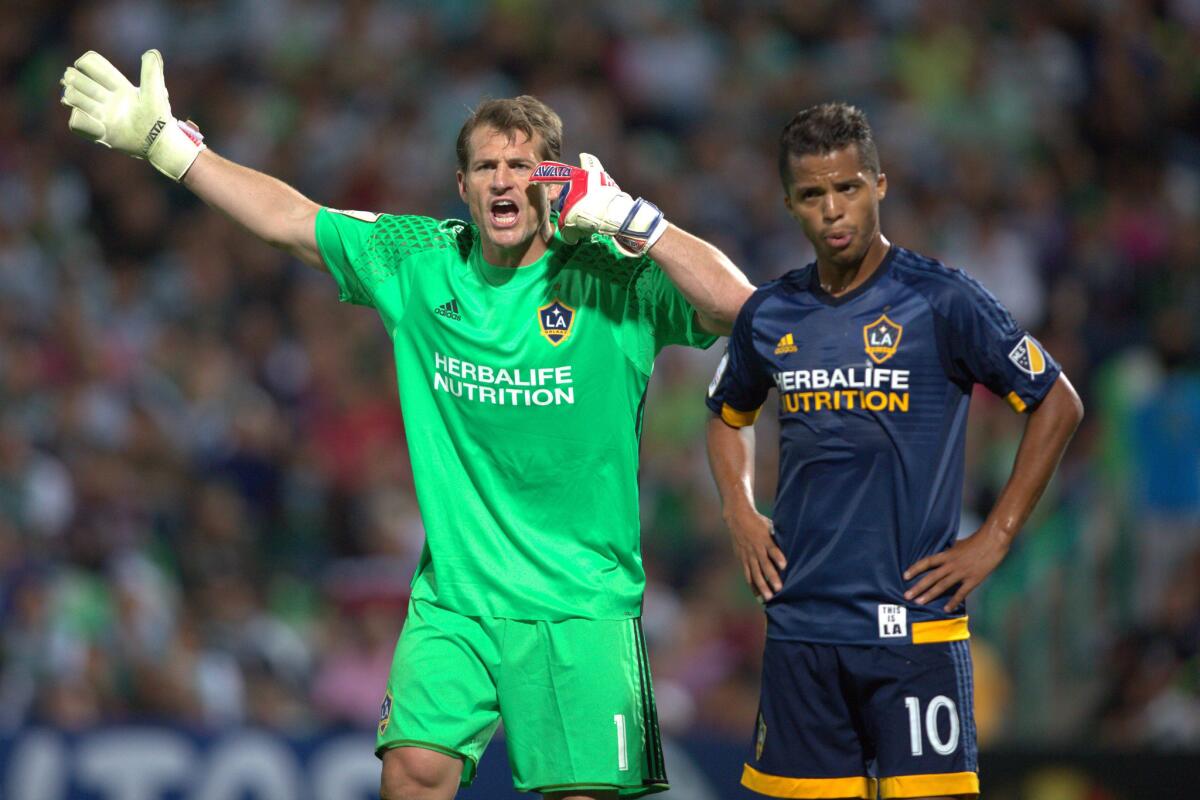Galaxy goalkeeper Dan Kennedy, left, and Giovani Dos Santos are seen during a CONCACAF Champions League quarterfinal match on March 1 in Mexico.