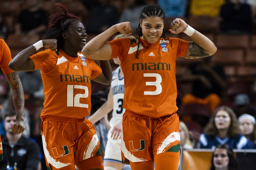 Miami's Ja'Leah Williams (12) and Destiny Harden (3) celebrate after Harden scored against Villanova in the first half of a Sweet 16 college basketball game of the NCAA Tournament in Greenville, S.C., Friday, March 24, 2023. (AP Photo/Mic Smith)
