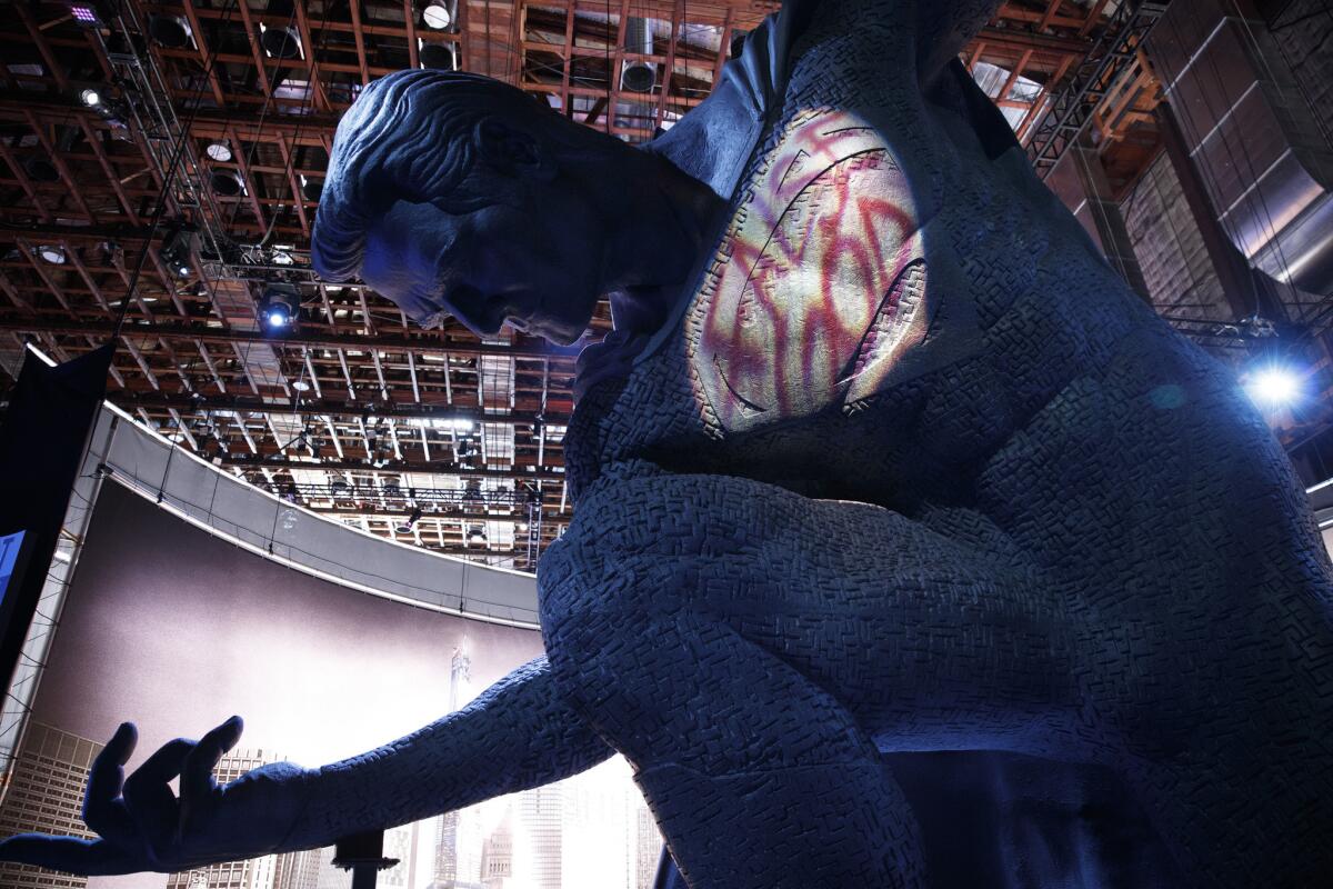 A set vignette showing a statue of Superman with graffiti on it is seen during a day of promotion for "Batman V Superman: Dawn of Justice," on the Warner Bros. studio lot in Burbank.