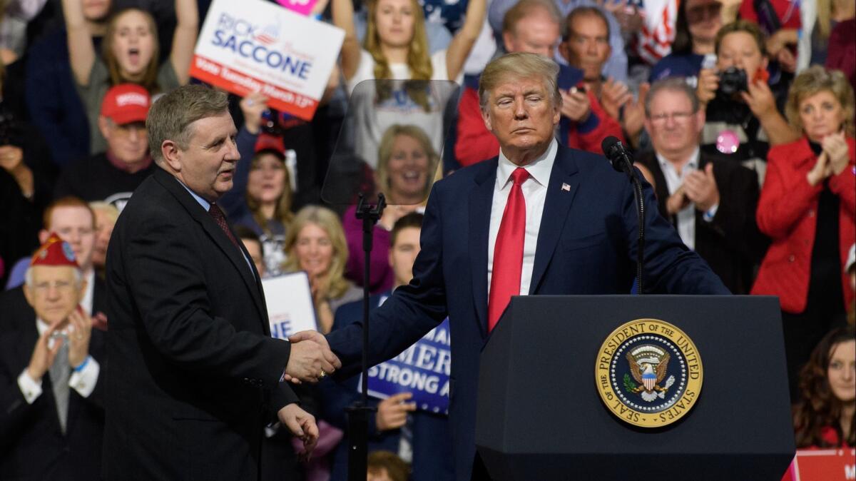 President Trump at a rally outside Pittsburgh on Saturday with Republican House candidate Rick Saccone.