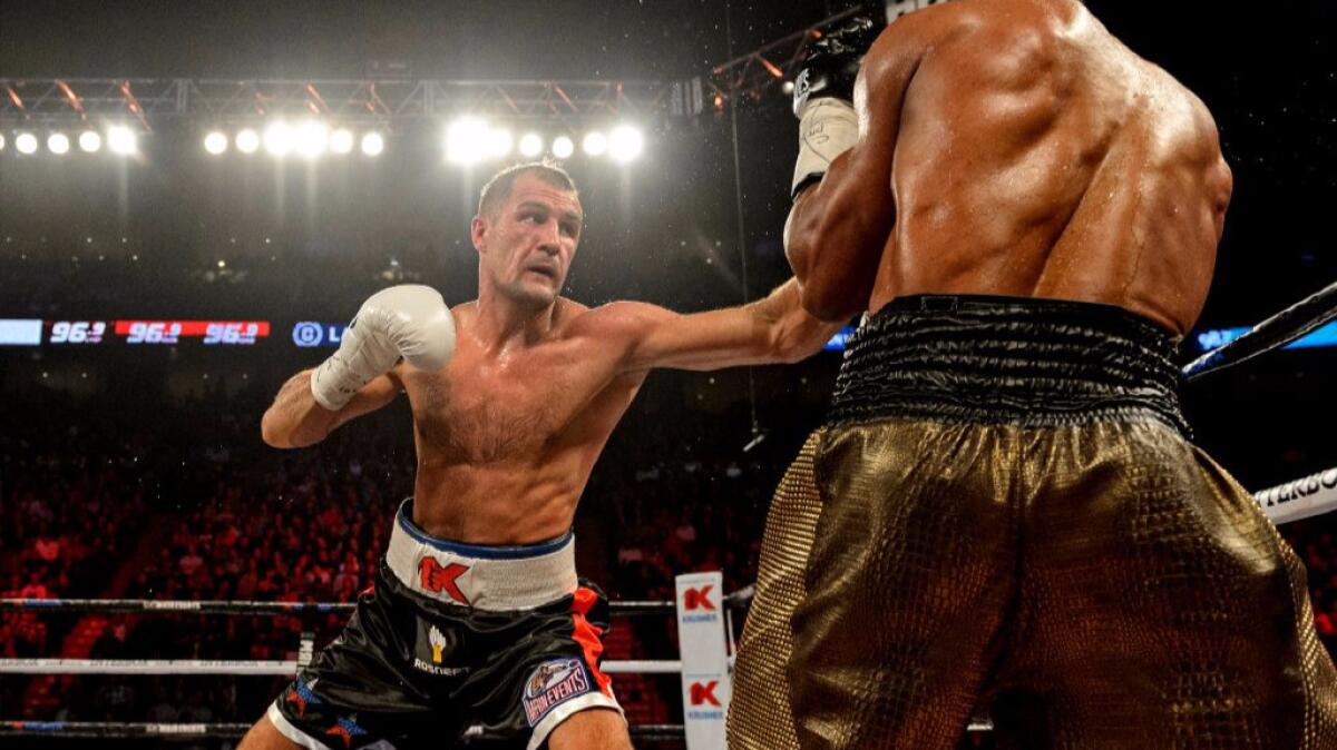 Sergey Kovalev of Russia lands a jab on Jean Pascal of Canada during a WBO, WBA, and IBF light-heavyweight world championship match on Jan. 30.