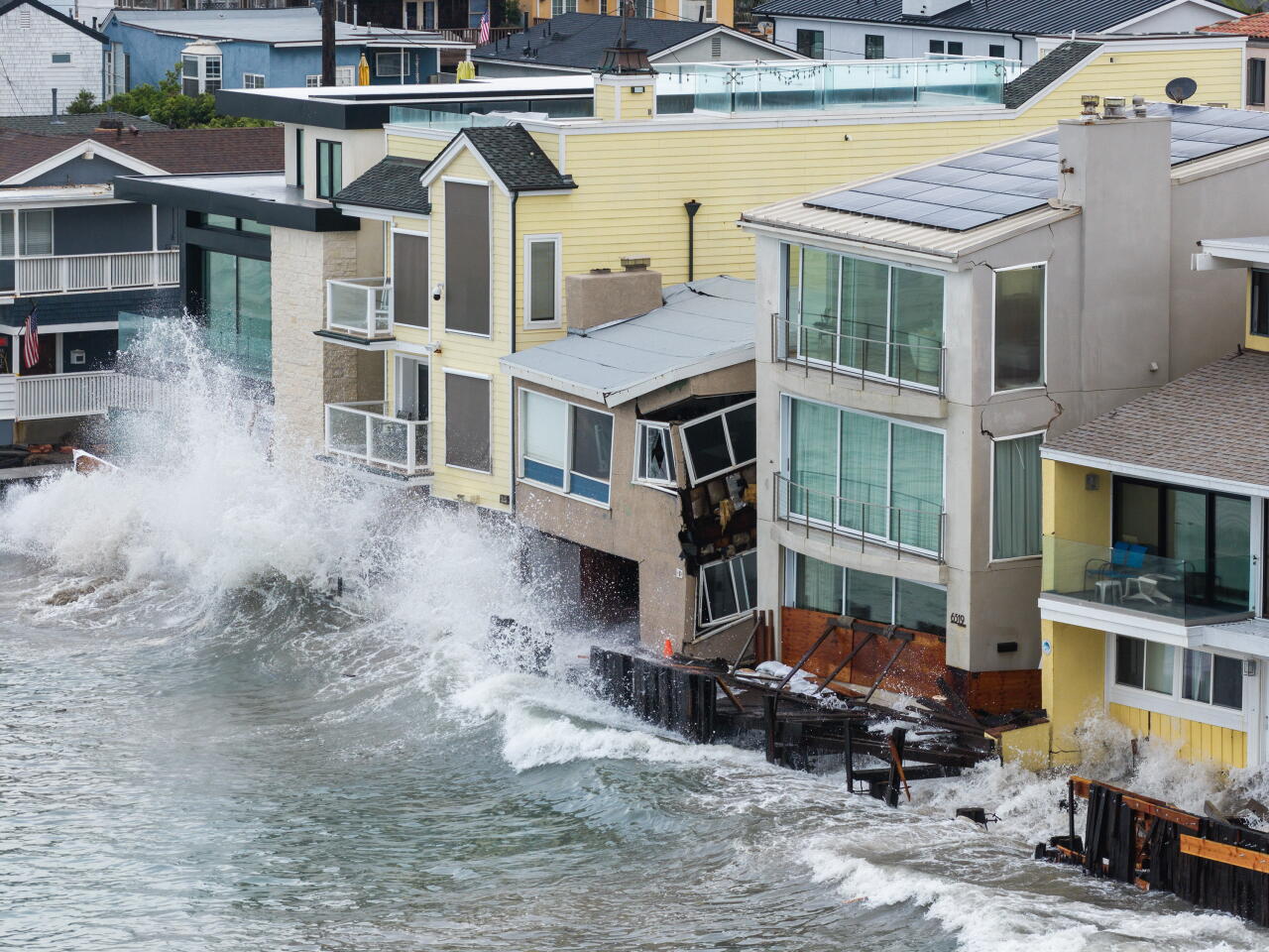 A drone view of waves crashing into the barrier and into homes on the Long Beach Peninsula
