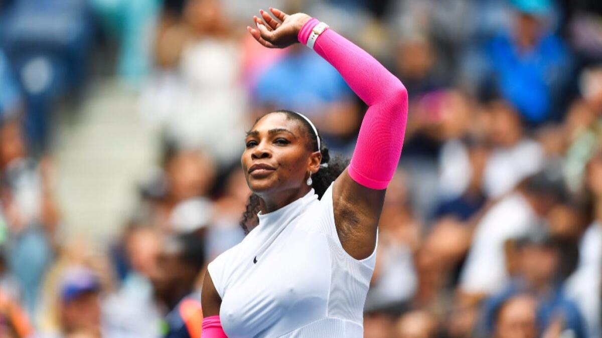 Serena Williams raises his arm after defeating Johanna Larsson of Sweden, 6-2, 6-1, at the U.S. Open.