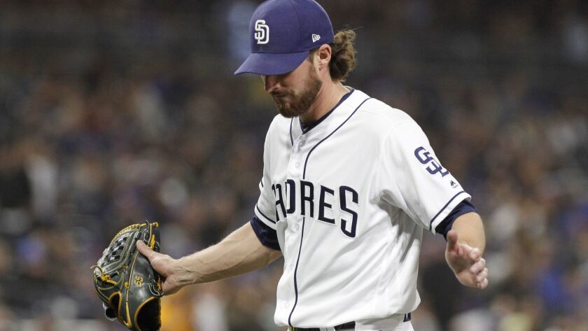 Padres starting pitcher Bryan Mitchell slaps his hand into his glove as he walks back to the dugout after giving up a run to the Dodgers in the fifth inning at Petco Park in San Diego on Tuesday, April 17, 2018.
