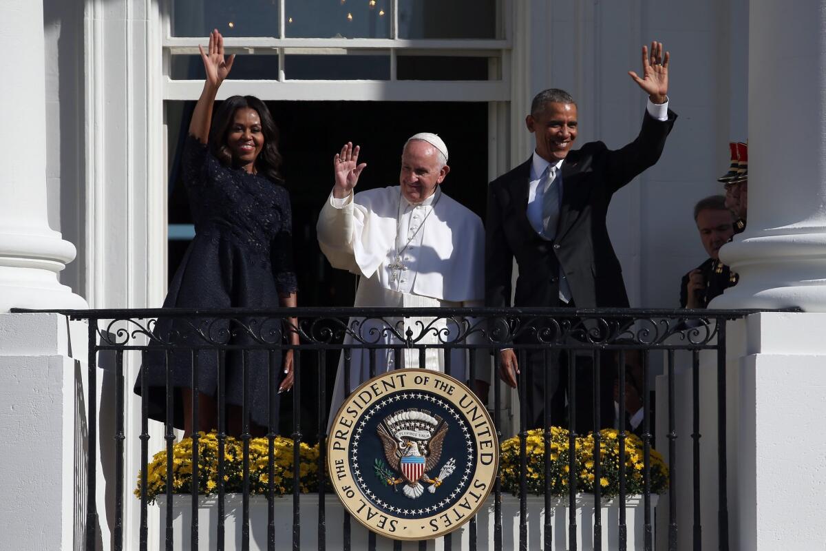 President Obama and First Lady Michelle Obama wave from the balcony with Pope Francis in an arrival ceremony at the White House.