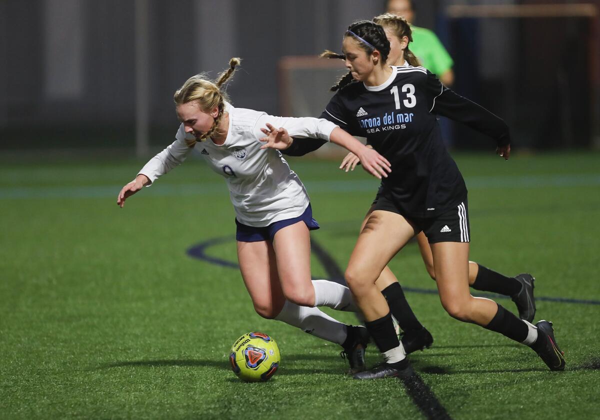 Newport Harbor's Brielle Benedict gets tangled up with CdM's Emily Chanawatr (13) during Thursday's match.