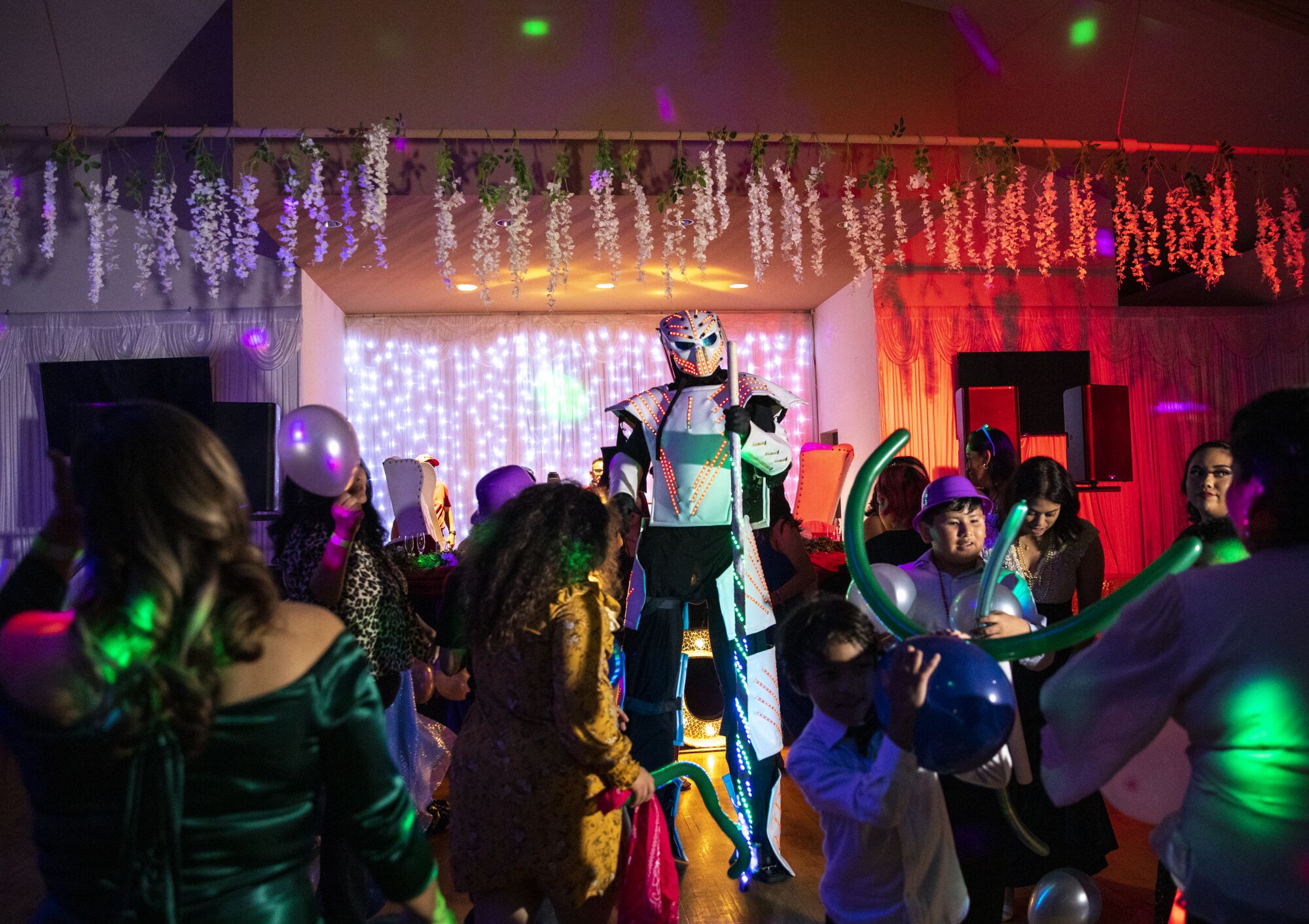 A robot surprises guests with balloons during a Twilight themed quinceanera at the Silverado Ballroom.