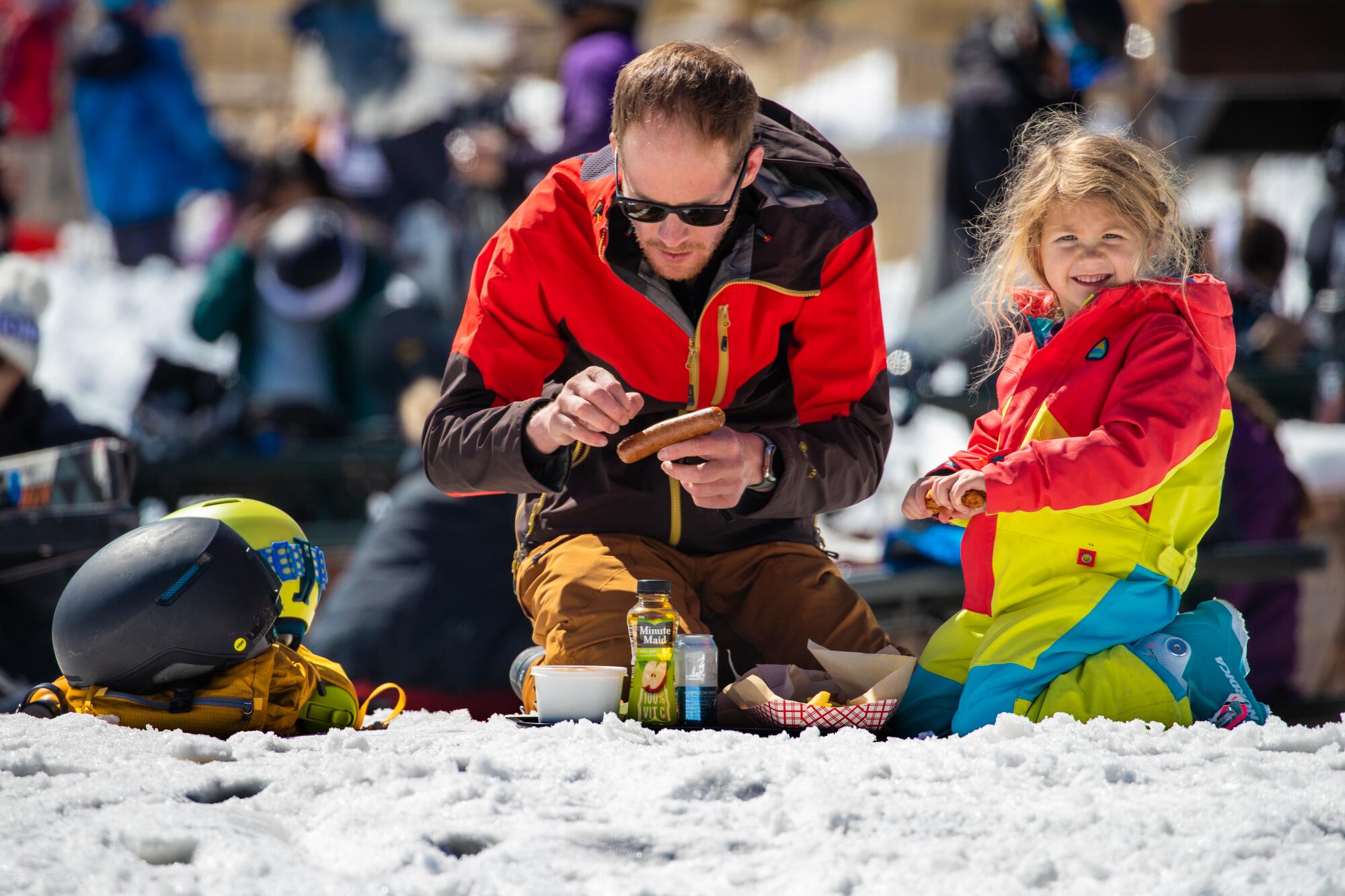 Steve Marion, with 4-year-old daughter Piper Mormon, sits down for lunch on a sunny day at Big Bear Mountain Resort.