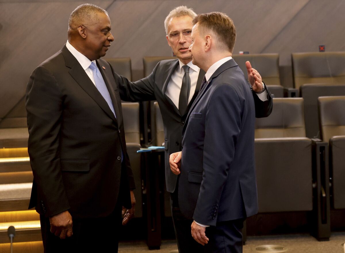 U.S. Secretary for Defense Lloyd J. Austin III, left, speaks with Poland's Defense Minister Mariusz Blaszczak, right, and NATO Secretary General Jens Stoltenberg during a meeting of the North Atlantic Council at NATO headquarters in Brussels, Wednesday, March 16, 2022. In talks at NATO's Brussels headquarters, U.S. Defense Secretary Lloyd Austin and his counterparts are weighing what defenses to erect on the organization's eastern flank, from Estonia in the north through Latvia, Lithuania and Poland down to Bulgaria and Romania on the Black Sea. (AP Photo/Olivier Matthys)