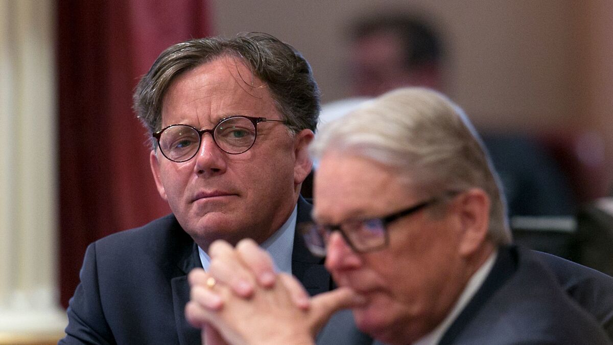 State Sen. Josh Newman, D-Fullerton, left, listens as lawmakers debate a recall election measure against him on Aug. 24, in Sacramento, Calif.