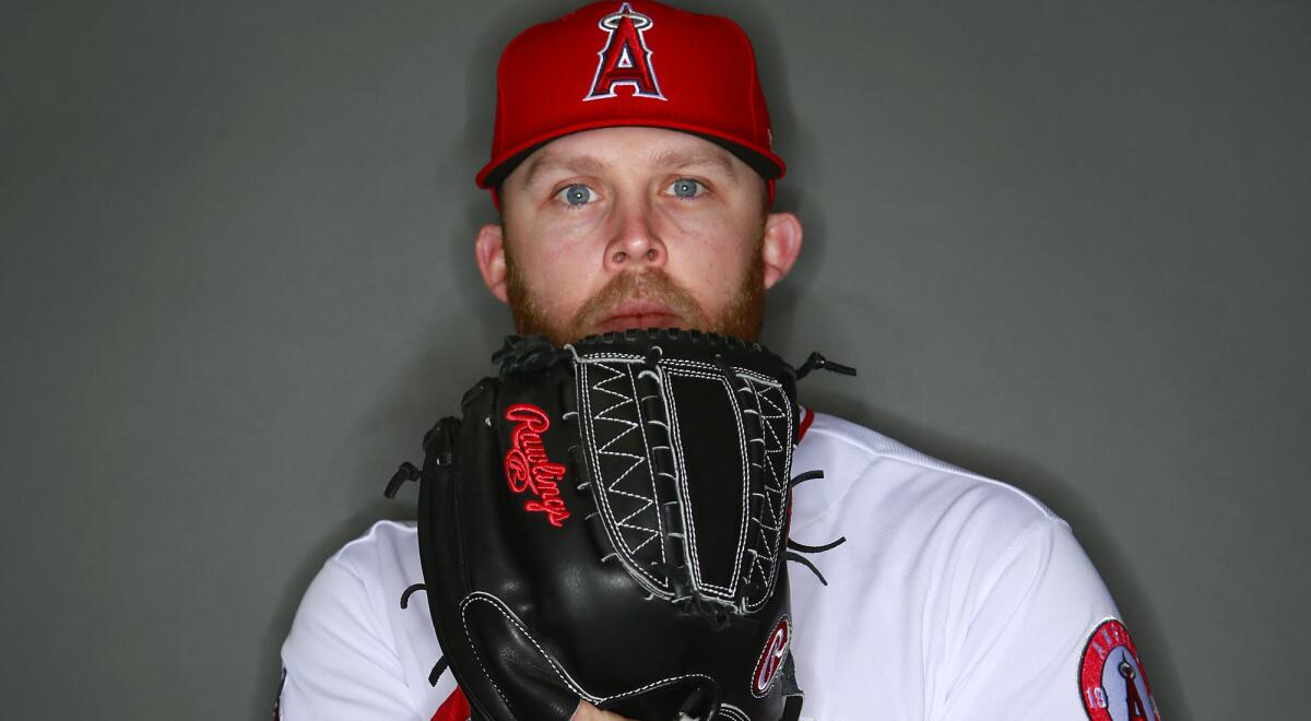 Angels relief pitcher Cody Allen strikes a pose for his media day photograph.