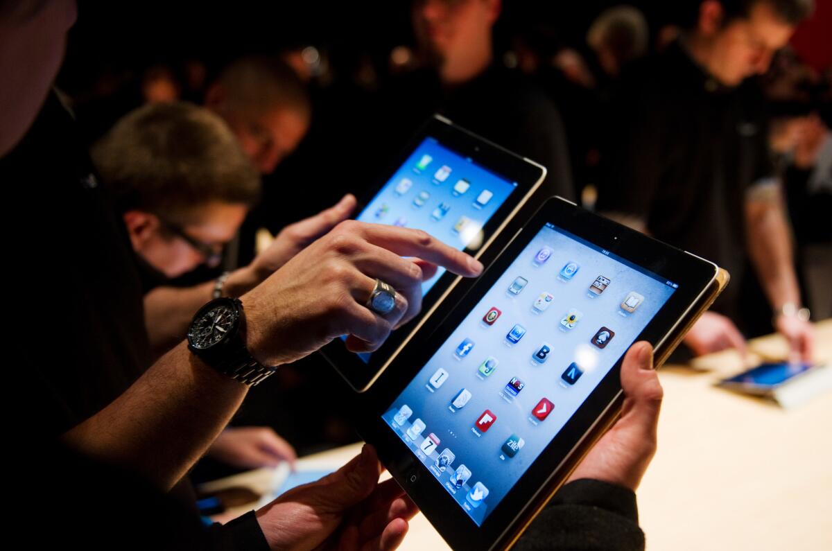 Journalists test the third-generation iPad following Apple's unveiling of the new tablet last week.