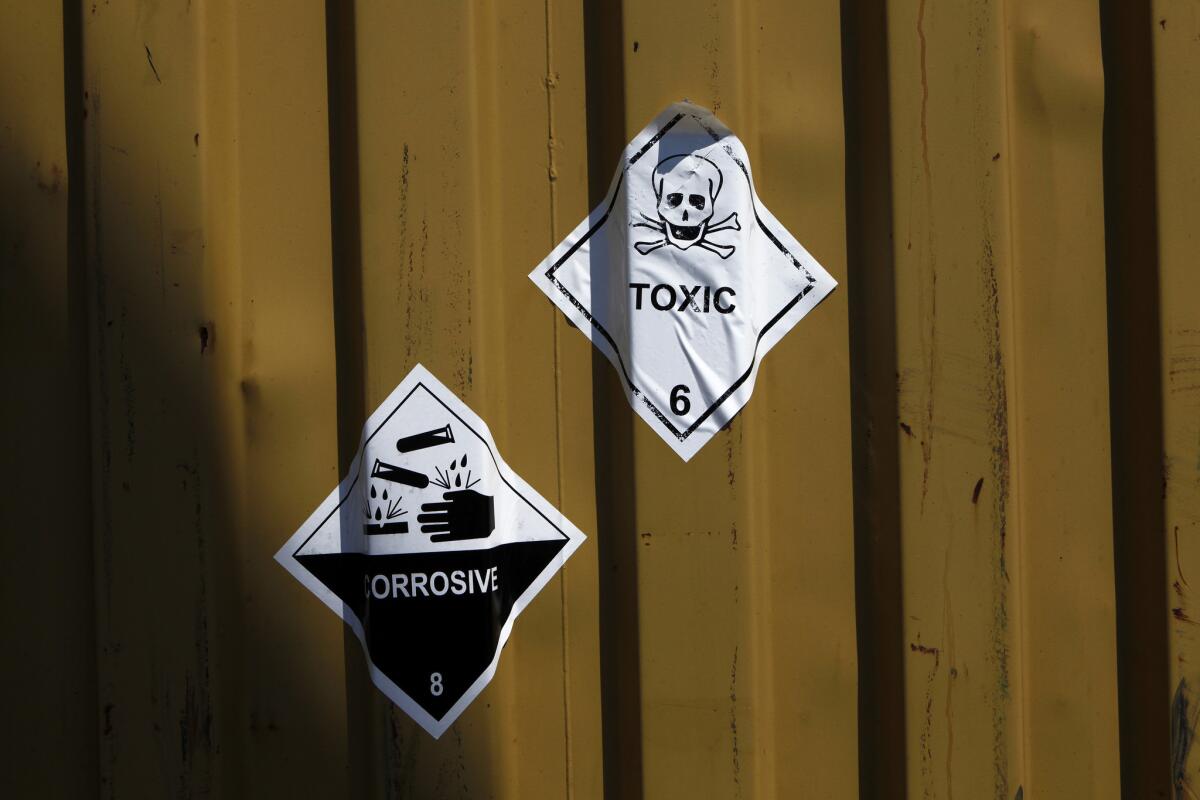 A sign reading "Toxic" is seen on containers carrying Syrian chemical weapons, which are being transported out of the country by way of Larnaca, Cyprus, on May 13.