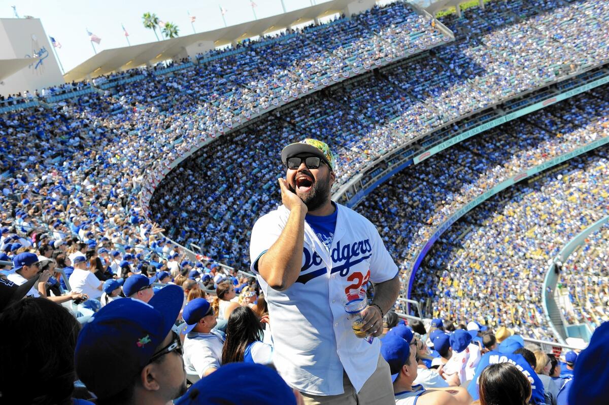 Dodger fans on Monday take in the Opening Day game against the San Diego Padres, which more than two-thirds of the L.A. TV market could not watch thanks to standoff between Time Warner Cable and other providers.