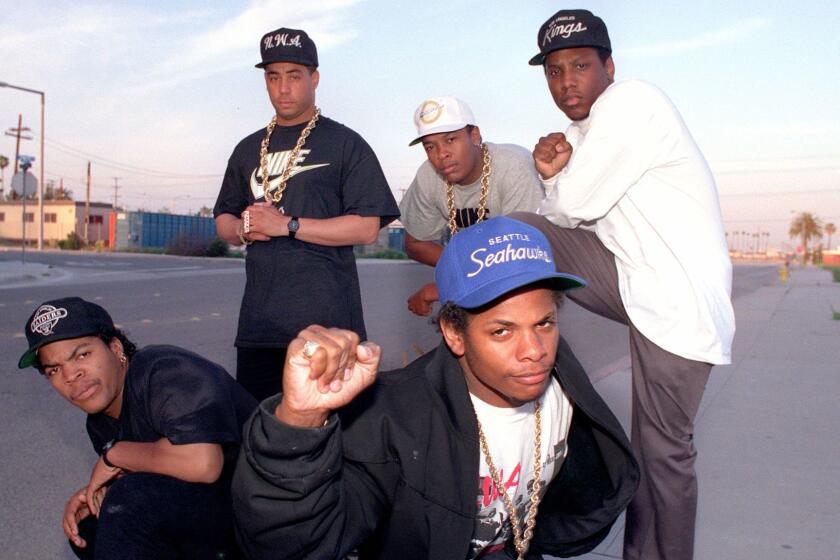 BACK: LR: D.J. Yellr, Dr. Dre & M.C. Ren (Kings cap) and LR: frontICE CUBE (w/Raiders cap) and Ease E. (Seahawks cap) March 23, 1989 L. A. Times staff photo.