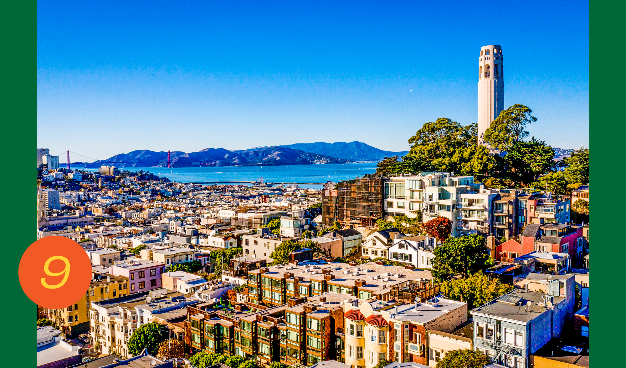Coit Tower, high on the hill, overlooks the North Beach District of San Francisco, with the bay in the distance
