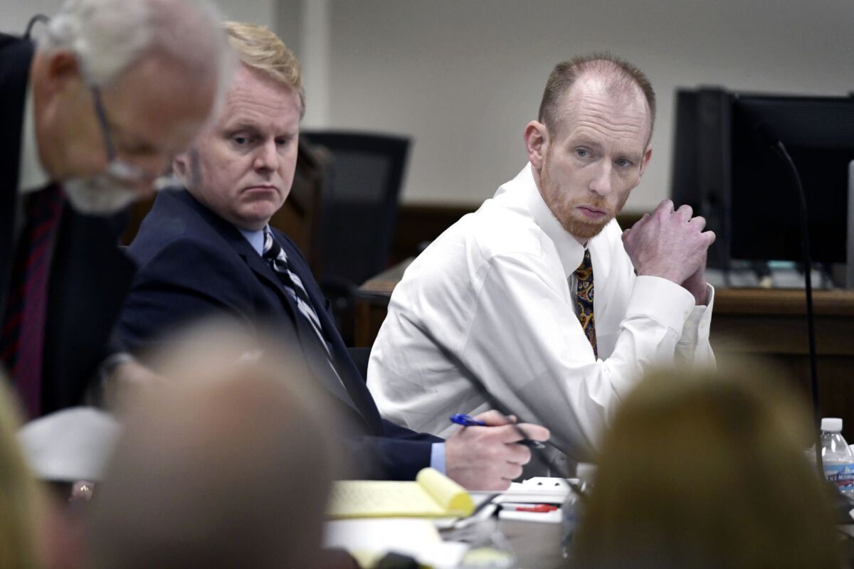 FILE - Chad Isaak, right, of Washburn, sits with his defense team during the third day of his murder trial at the Morton County Courthouse in Mandan, N.D., on Wednesday, Aug. 4, 2021. Authorities say Isaak, convicted in a 2019 quadruple slaying, has killed himself in prison. Isaak was appealing his convictions in the killings of the owner of a Mandan property management business and three workers there. (Mike McCleary/The Bismarck Tribune via AP, File)
