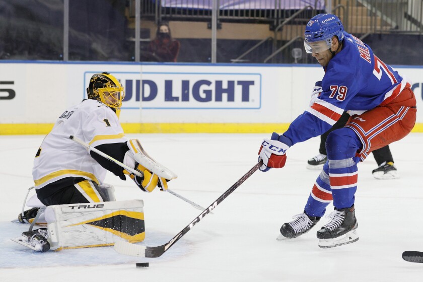 New York Rangers' K'Andre Miller (79) shoots as Pittsburgh Penguins' Casey DeSmith (1) defends during the second period of an NHL hockey game at Madison Square Garden, Monday, Feb. 1, 2021, in New York. (Sarah Stier/Pool Photo via AP)