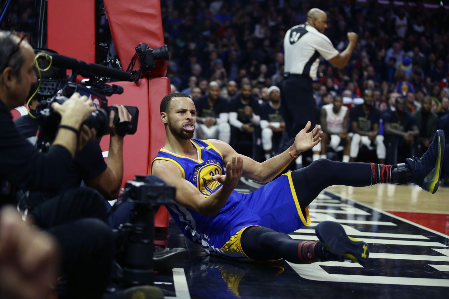 Warriors guard Stephen Curry looks for a foul call after scoring on a layup against the Clippers during the second half.