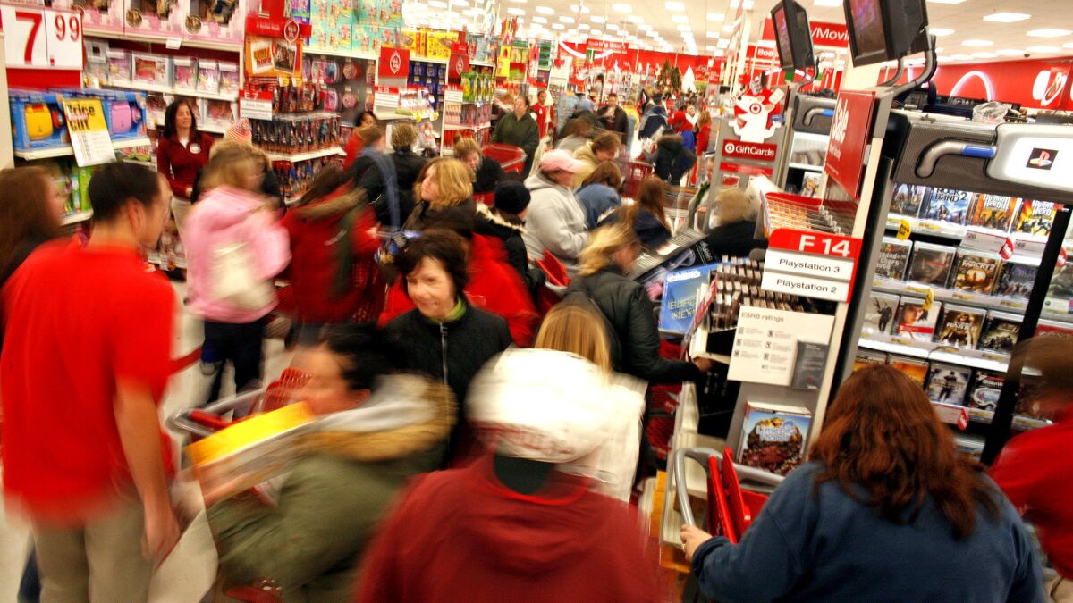 Holiday shoppers race around for gifts inside a Target store on the day after Thanksgiving of 2008 in Pleasant Prairie, Wisc. This year, Target and other retailers are trying various strategies to reduce lines and other annoying aspects of in-store shopping.