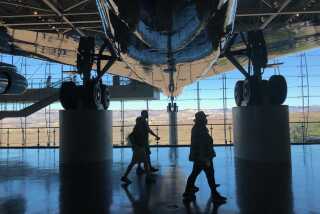 The Negron family of Santa Clarita walks beneath the decommissioned Air Force One jet that transported President Ronald Reagan and other commanders in chief. The aircraft is on display at the Reagan Presidential Library in Simi Valley.